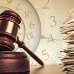 Gavel beside a clock and stacked case files, symbolizing decades-old court case backlogs the new bar leadership has pledged to clear
