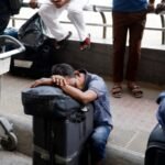 Travelers with luggage at an airport, representing Indian students whose exams were disrupted by conflict in West Asia