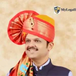 Portrait of Devendra Fadnavis wearing a traditional red Maharashtrian turban and Nehru jacket