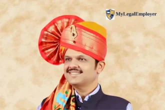 Portrait of Devendra Fadnavis wearing a traditional red Maharashtrian turban and Nehru jacket