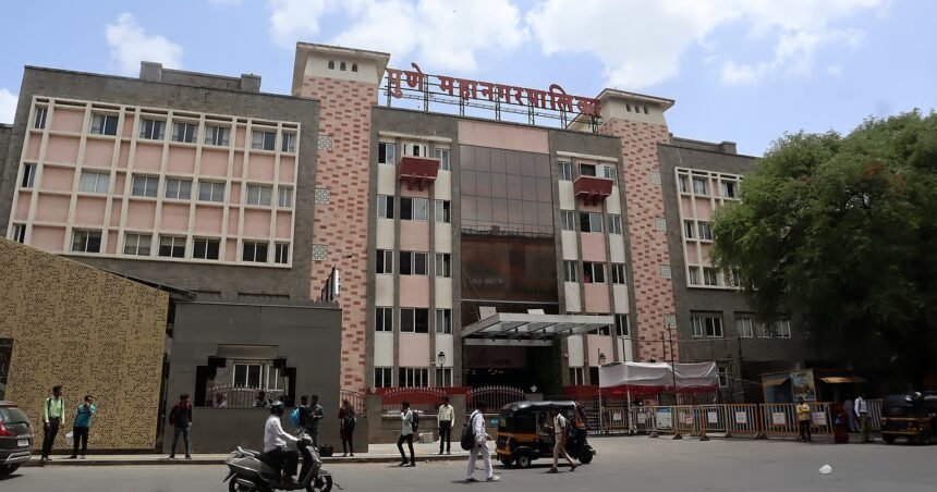 Exterior of the Pune Municipal Corporation building with people and vehicles outside