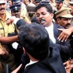 Police officers and a lawyer in a black robe in a tense, crowded confrontation