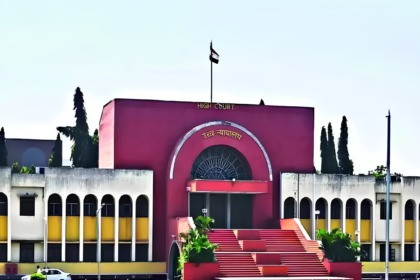 Maroon-colored Bombay High Court building facade with an Indian flag on the roof